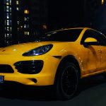 a yellow car parked on the street at night