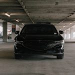 a black car parked in a parking garage