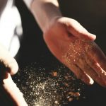 person's hand with dust during daytime