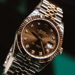 silver and gold round analog watch at 10 10