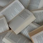 white and brown book on brown woven surface