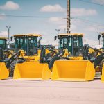 yellow and black heavy equipment on snow covered ground during daytime
